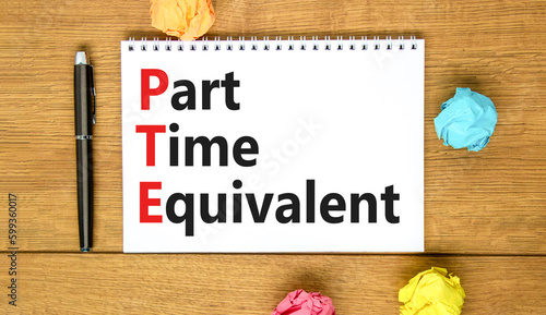 PTE Part time equivalent symbol. Concept words PTE Part time equivalent on white note. Beautiful wooden table wooden background. Business and PTE Part time equivalent concept. Copy space.
