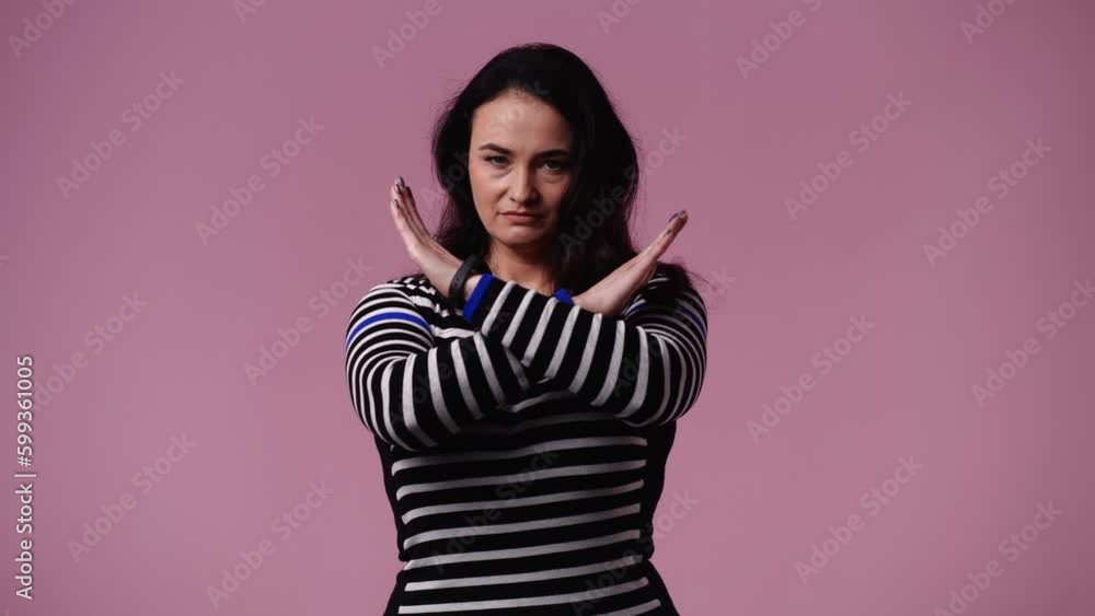 4k video of one woman which stops and responds negatively to something over pink background. 4k video of one woman which stops and responds negatively to something over pink background.