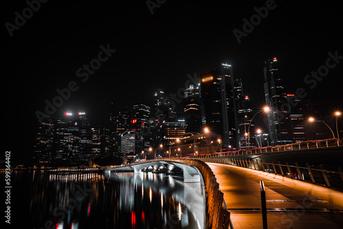 Vibrant Singapore skyline at night. Iconic buildings and modern architecture are illuminated in a dazzling display of lights, creating a mesmerizing view.