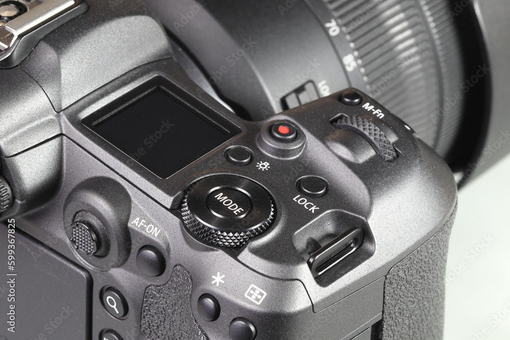 Close up top panel of professional Mirrorless Digital Camera, DSLR, show on camera mode command functional dial, function lock, light, Video record, multi function button, af-on and joystick.
