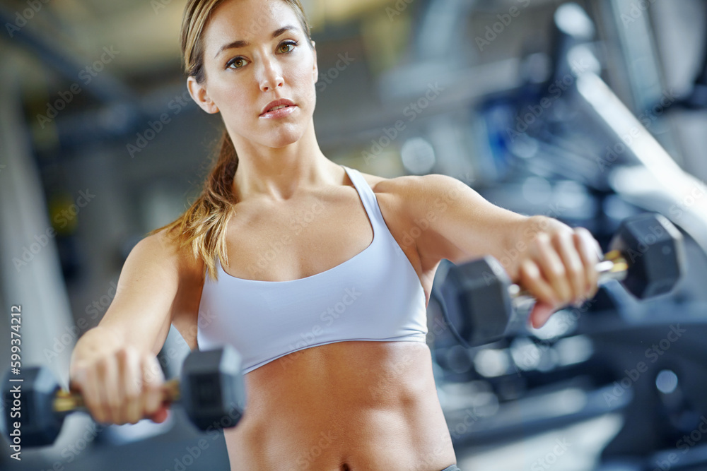 Im making great progress. A beautiful young woman working out at the gym. Im making great progress. A beautiful young woman working out at the gym.