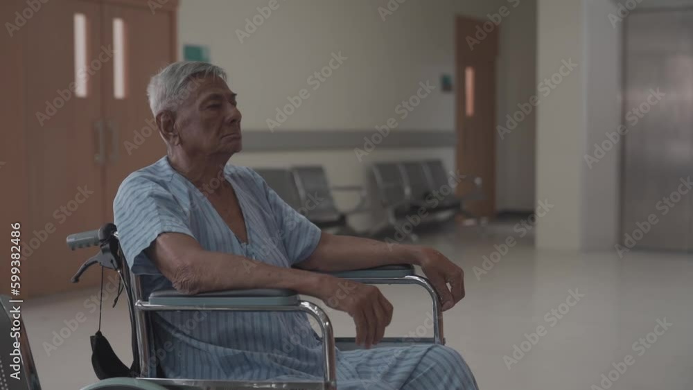 concept hospitality medical and health care services. the elderly male patient sits and waits in the wheel chair in front of check up room in the hospital. concept hospitality medical and health care services. the elderly male patient sits and waits in the wheel chair in front of check up room in the hospital.