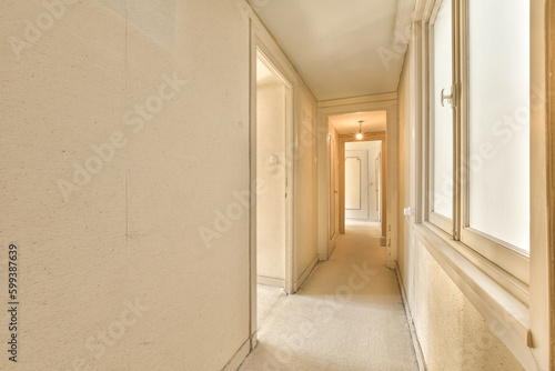 an empty hallway with no one person in the room to be seen on the right, and another view from the left