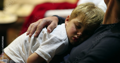 Child sleeping on father chest at night, parent and son relationship