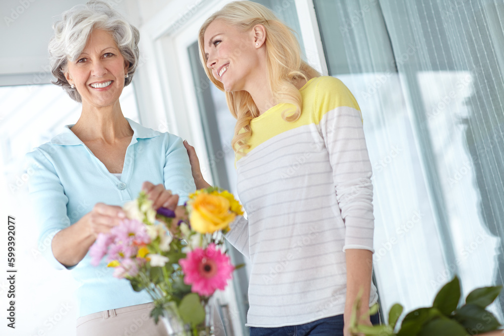 She knows just how to cheer you up. a senior woman enjoying some flower arranging with her daughter.