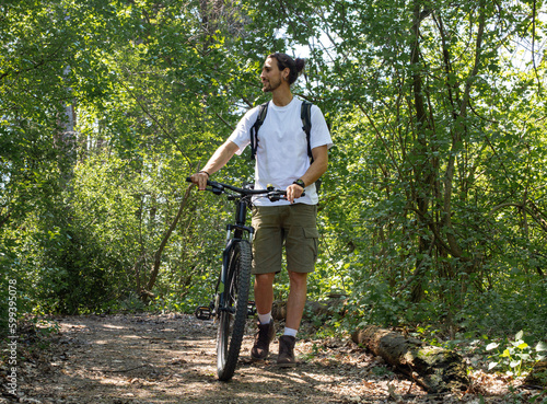 Man in forest with bicycle