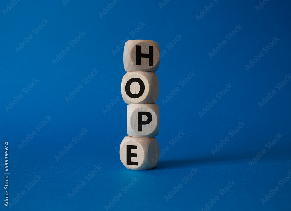 Hope symbol. Concept word Hope on wooden cubes. Beautiful blue background. Business and Hope concept. Copy space. Hope symbol. Concept word Hope on wooden cubes. Beautiful blue background. Business and Hope concept. Copy space.