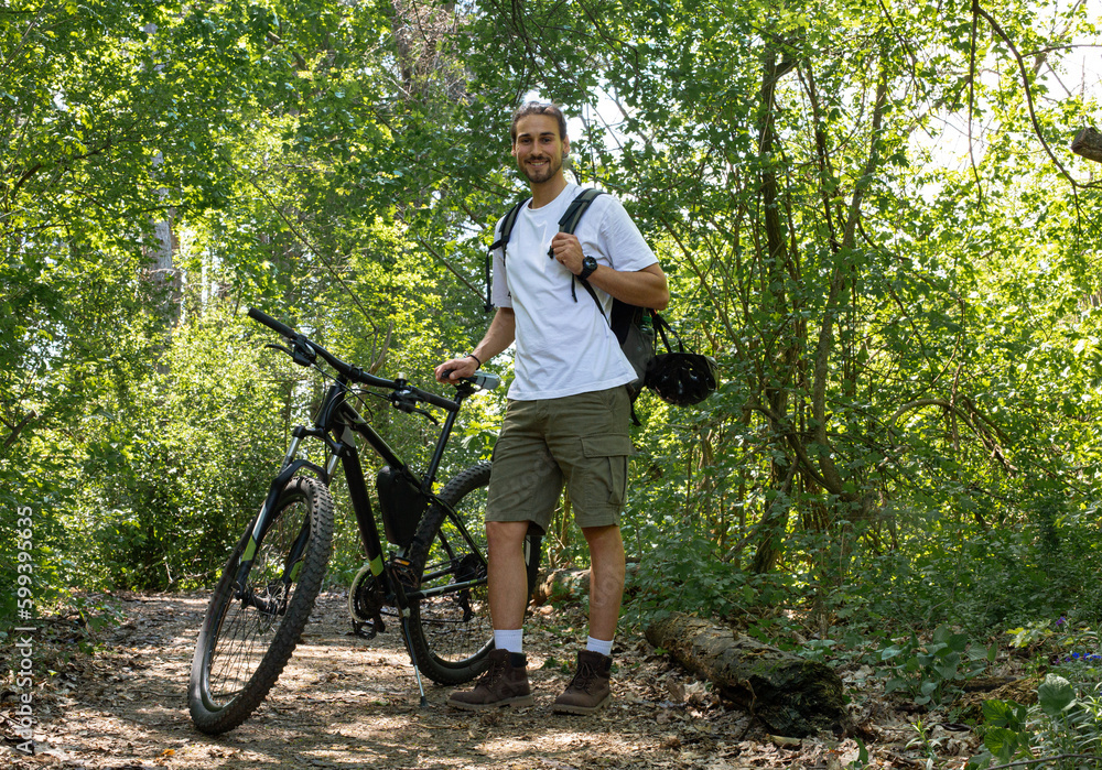 Man in forest with bicycle