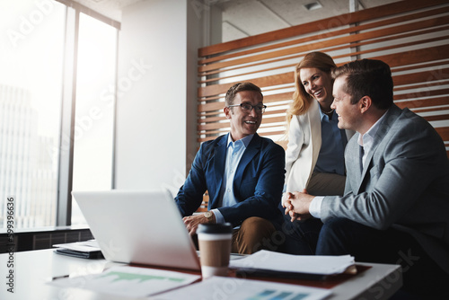 Working as a team of high-ranking executives. a group of businesspeople having a discussion in an office.