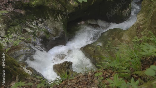 Water flowing around stones. Creek in the mountains. Taubenlochschlucht, Taubenloch Gorge, Biel/Bienne, Switzerland photo