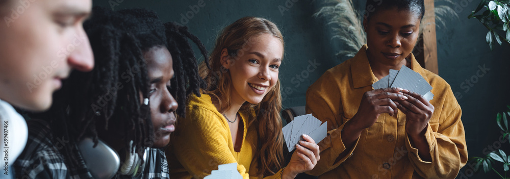 Group of diverse friends playing game on mobile phone Stock Photo