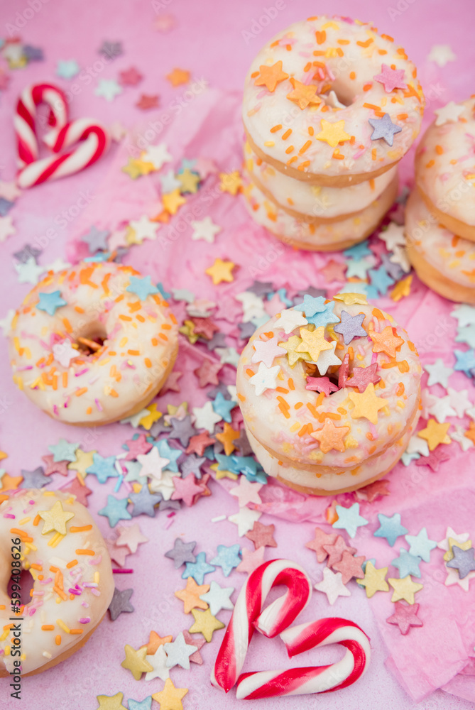 donuts with sprinkles on pink background donuts with sprinkles on pink background