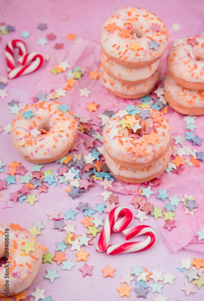 donuts with sprinkles on pink background donuts with sprinkles on pink background