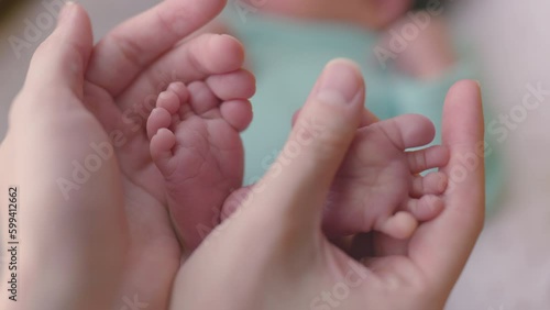 Wallpaper Mural Baby feet in mother hands. Tiny Newborn Baby's feet on female Heart Shaped hands closeup. Mom and her Child. Happy Family concept. Beautiful conceptual video of Maternity. Torontodigital.ca