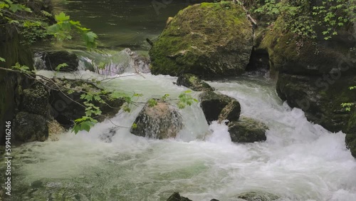 Water flowing around stones. Creek in the mountains. Taubenlochschlucht, Taubenloch Gorge, Biel/Bienne, Switzerland photo