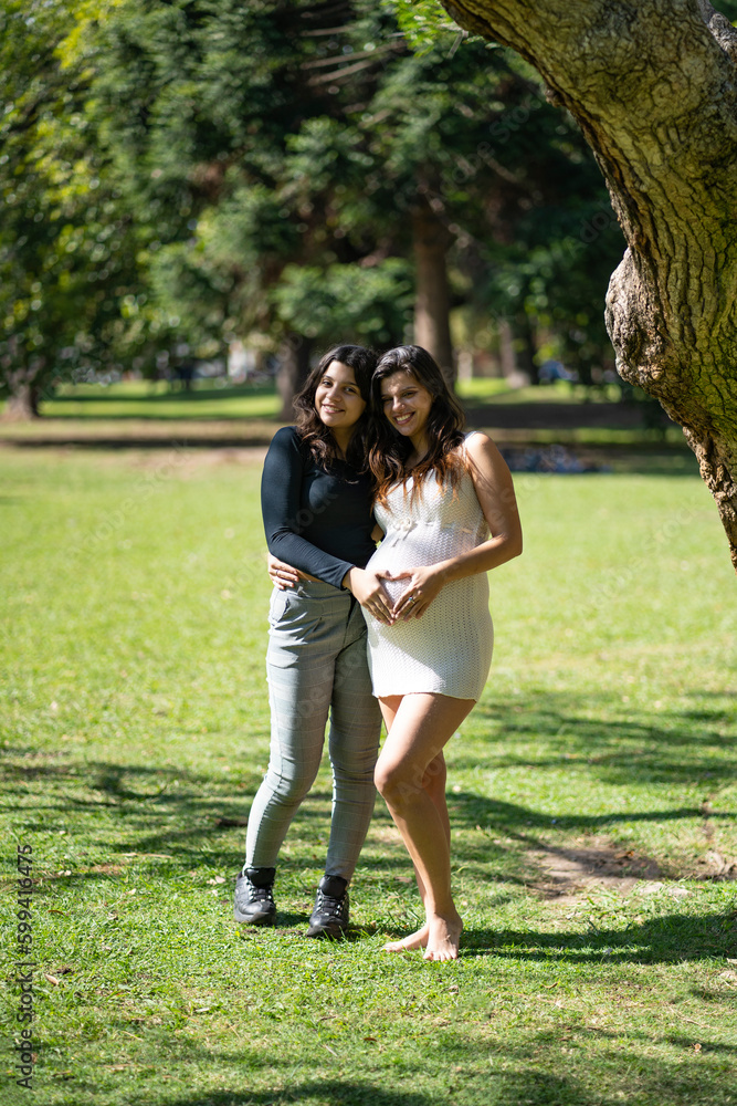 Fototapeta premium Happy pregnant lesbian couple at outdoors. LGBT