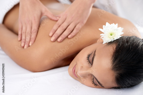 Get balanced through massage therapy. a beautiful young woman relaxing during spa treatment.