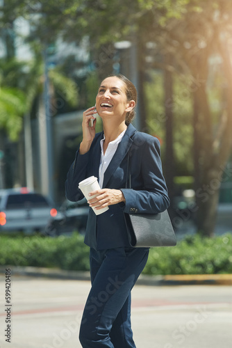 The joys of having a successful career. a young businesswoman talking on her phone while out in the city. © GR/peopleimages.com