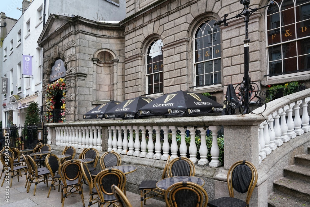 Chairs and tables set up on the sidewalk in front of Powerscourt
