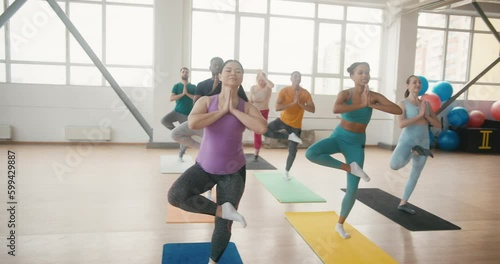People try to do tadasana during beginner yoga session photo