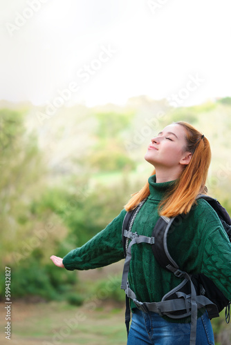 Backpacker woman in the mountain breathing fresh air. Trekking concept.