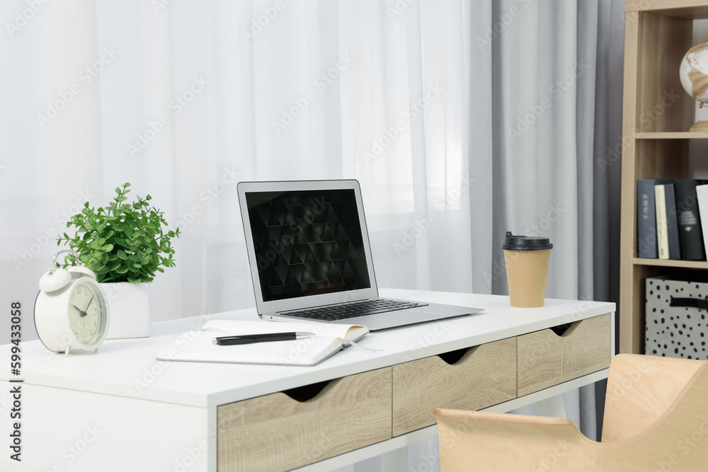 Workplace with modern laptop on desk at home Workplace with modern laptop on desk at home