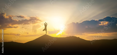 Silhouette of woman practicing yoga under beautiful sky at sunset, banner design