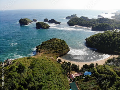 The beautiful landscape and scenery of ocean during sunset and sunny day. The long coastal beach with sand and rocky beach. Location in Pacitan, East Java Province, Indonesia.