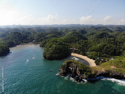 The beautiful landscape and scenery of ocean during sunset and sunny day. The long coastal beach with sand and rocky beach. Location in Pacitan, East Java Province, Indonesia.