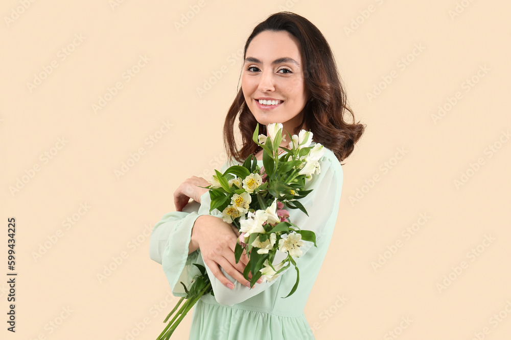 Young woman in dress with alstroemeria flowers on beige background Young woman in dress with alstroemeria flowers on beige background