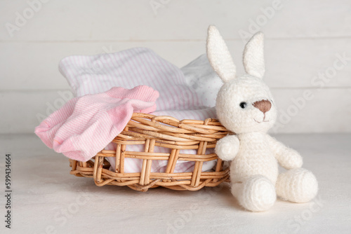 Basket with baby clothes an...