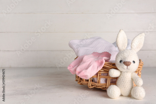 Basket with baby clothes an...