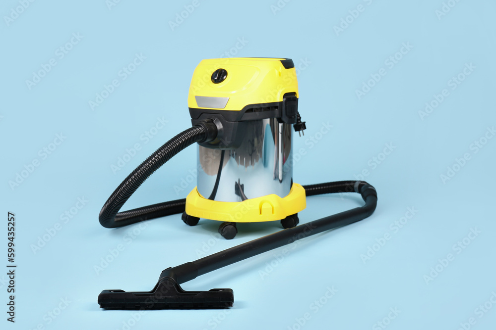 Vacuum cleaner on blue background Vacuum cleaner on blue background