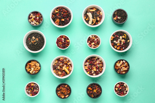 Assortment with different types of dried fruit tea on turquoise background
