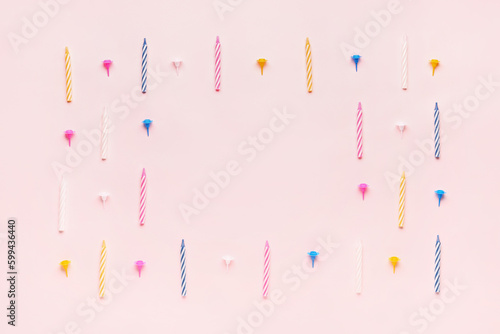 Tela Frame made of colorful birthday candles on pink background