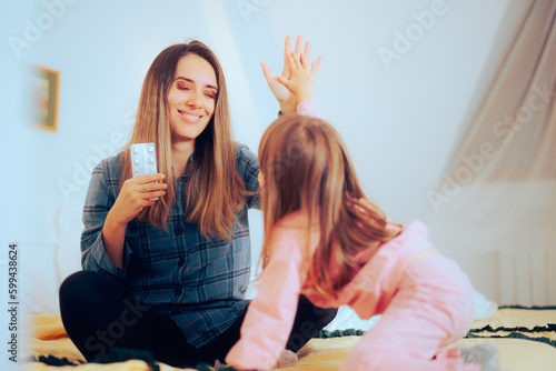 Murais de parede Mother and Daughter Making High Five Gesture after Taking Medication