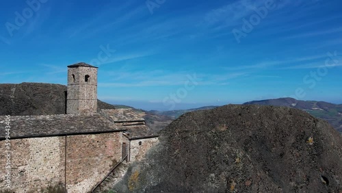 Europe, Italy, Travo , Drone failure aerial footage of Pietra Perduca, volcanic rock, church set at top stone immersed in countryside landscape, cultivated land in Val Trebbia Bobbio photo