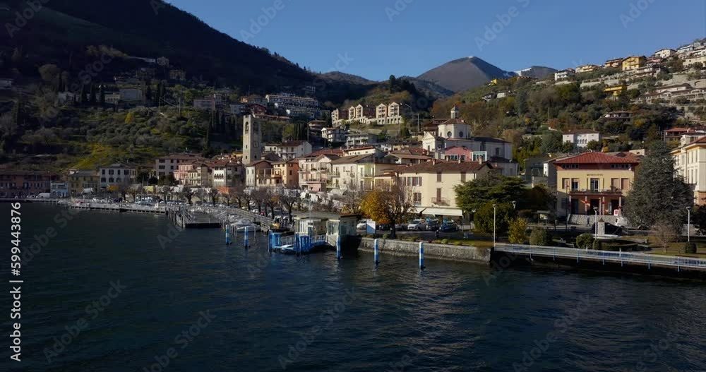 Tavernola Bergamasca picturesque village in northern Italy. Aerial drone sideways over Iseo Lake Tavernola Bergamasca picturesque village in northern Italy. Aerial drone sideways over Iseo Lake