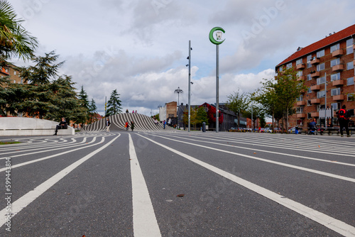 Selective focus and low angle view at white stripe pattern of outdoor exterior view at Superkilen park and The Black Square public park with outstanding design in Copenhagen, Denmark. 
 photo