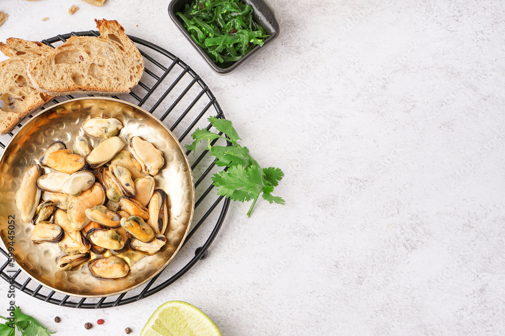 Plate of pickled mussels on grey background