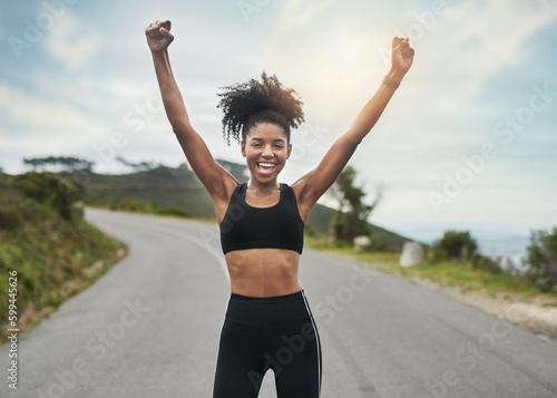 Im achieving all of my goals. Cropped portrait of an attractive young sportswoman cheering in celebration outside. © Delmaine D/peopleimages.com