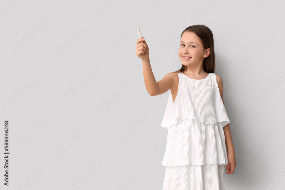 Little girl with chalk piece on light background. Children's Day celebration Little girl with chalk piece on light background. Children's Day celebration