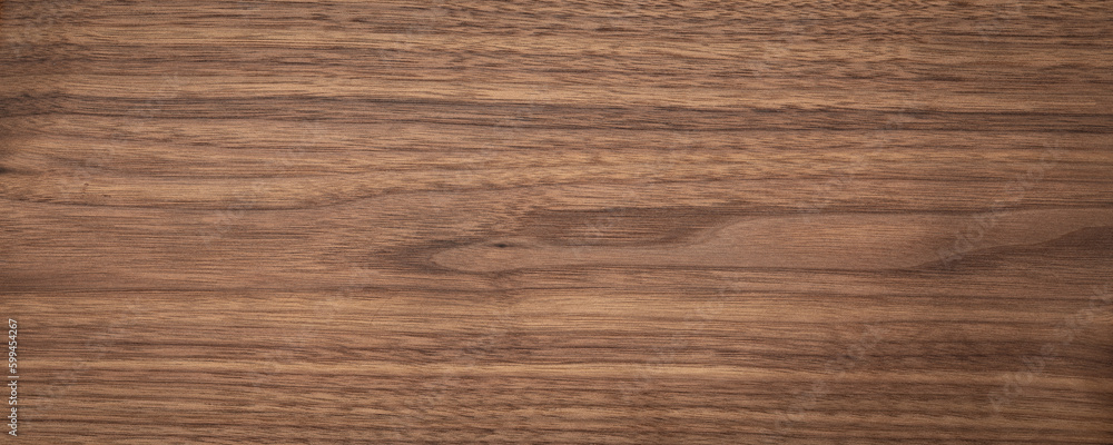 Natural walnut grain with beautiful wood grain. Walnut long planks texture. Walnut wood texture background. Natural walnut grain with beautiful wood grain. Walnut long planks texture. Walnut wood texture background.