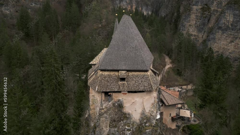 San Romedio or Saint Romedius sanctuary perched on rock, Predaia in Northern Italy. Aerial backward ascending San Romedio or Saint Romedius sanctuary perched on rock, Predaia in Northern Italy. Aerial backward ascending