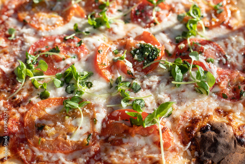 close up of pizza with vegetables, focus in the center, shallow depth of field