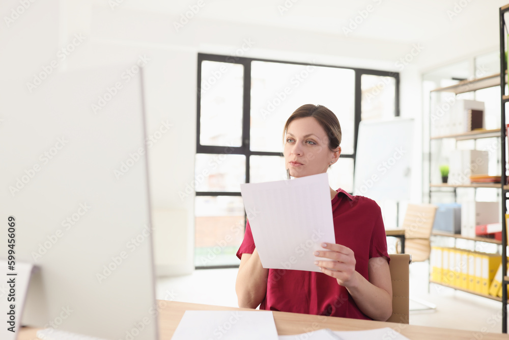 Secretary holds project paper in hands thinking of new ideas Secretary holds project paper in hands thinking of new ideas