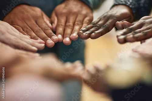 Uniting together no matter their differences. Closeup shot of a group of university students joining their hands together in unity.