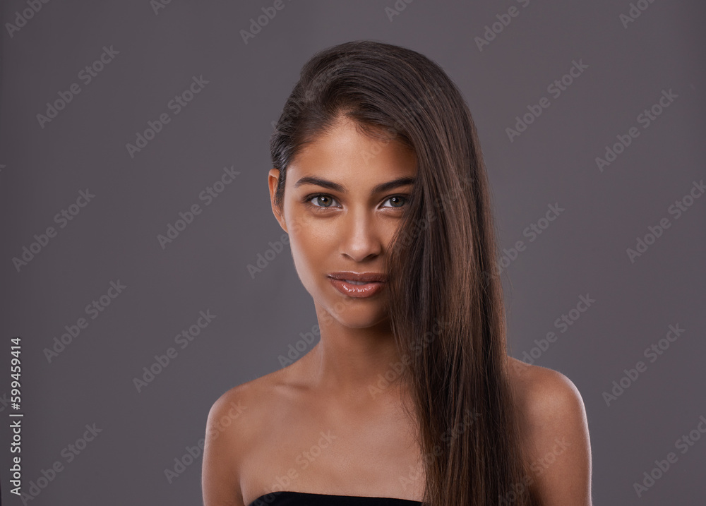 True beauty means keeping it natural. Portrait of a beautiful young woman posing in the studio. True beauty means keeping it natural. Portrait of a beautiful young woman posing in the studio.