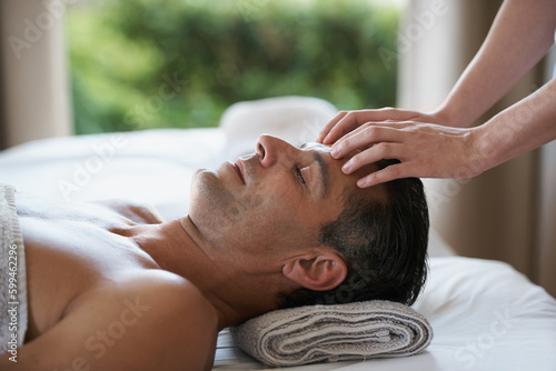 Enjoying a head massage. a mature man enjoying a relaxing masasage. photo