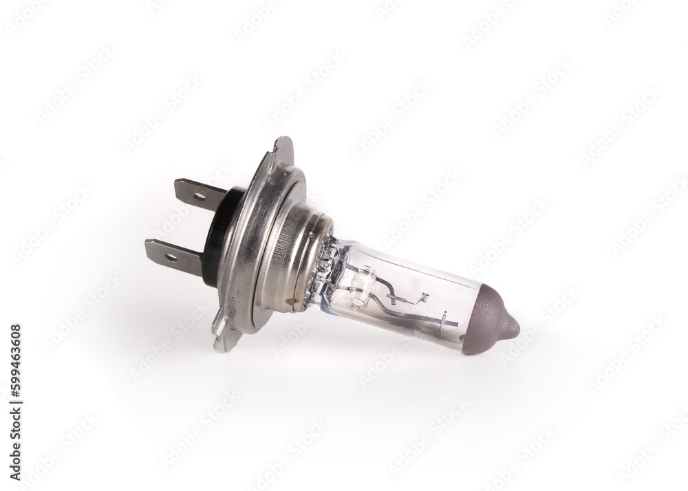 Isolated car headlight bulb burned out. Side view of small damaged halogen auto bulb used for headlight in vehicles. Type h7. White background. Selective focus. Isolated car headlight bulb burned out. Side view of small damaged halogen auto bulb used for headlight in vehicles. Type h7. White background. Selective focus.